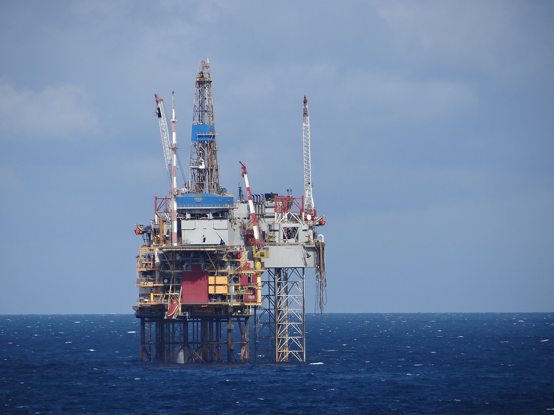 Offshore oil and gas production platform standing in open sea