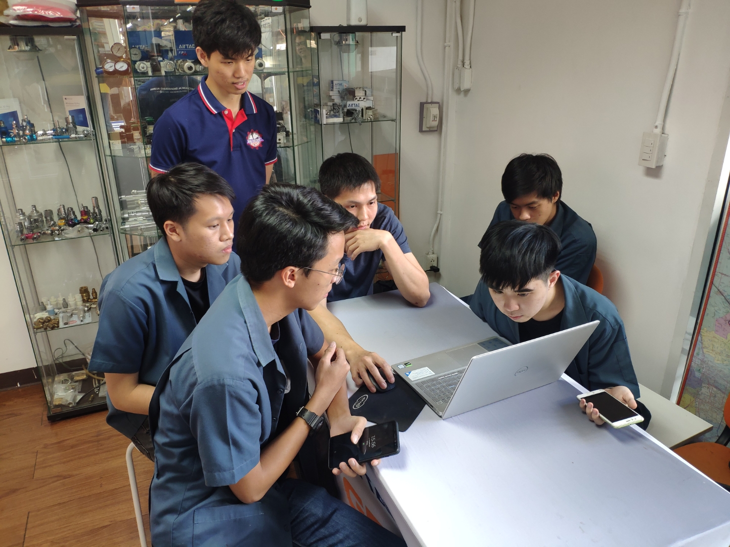 The team working on the vehicle in the workshop